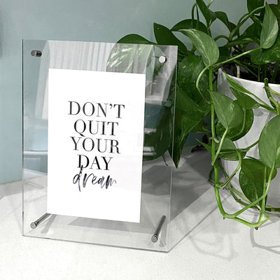 Clear Acrylic Photo Frame with Chrome legs, showing typogrpahic print inside