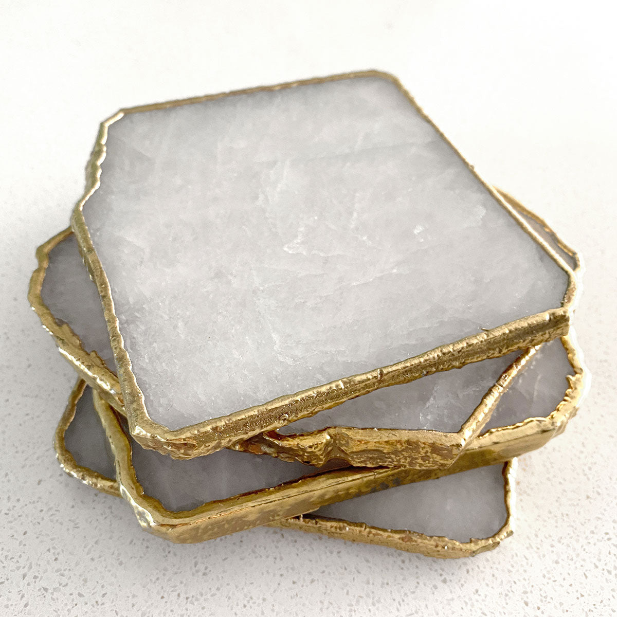 Agate Gold Edged Coasters in White Agate. Set of 4 stacked on top of each other.