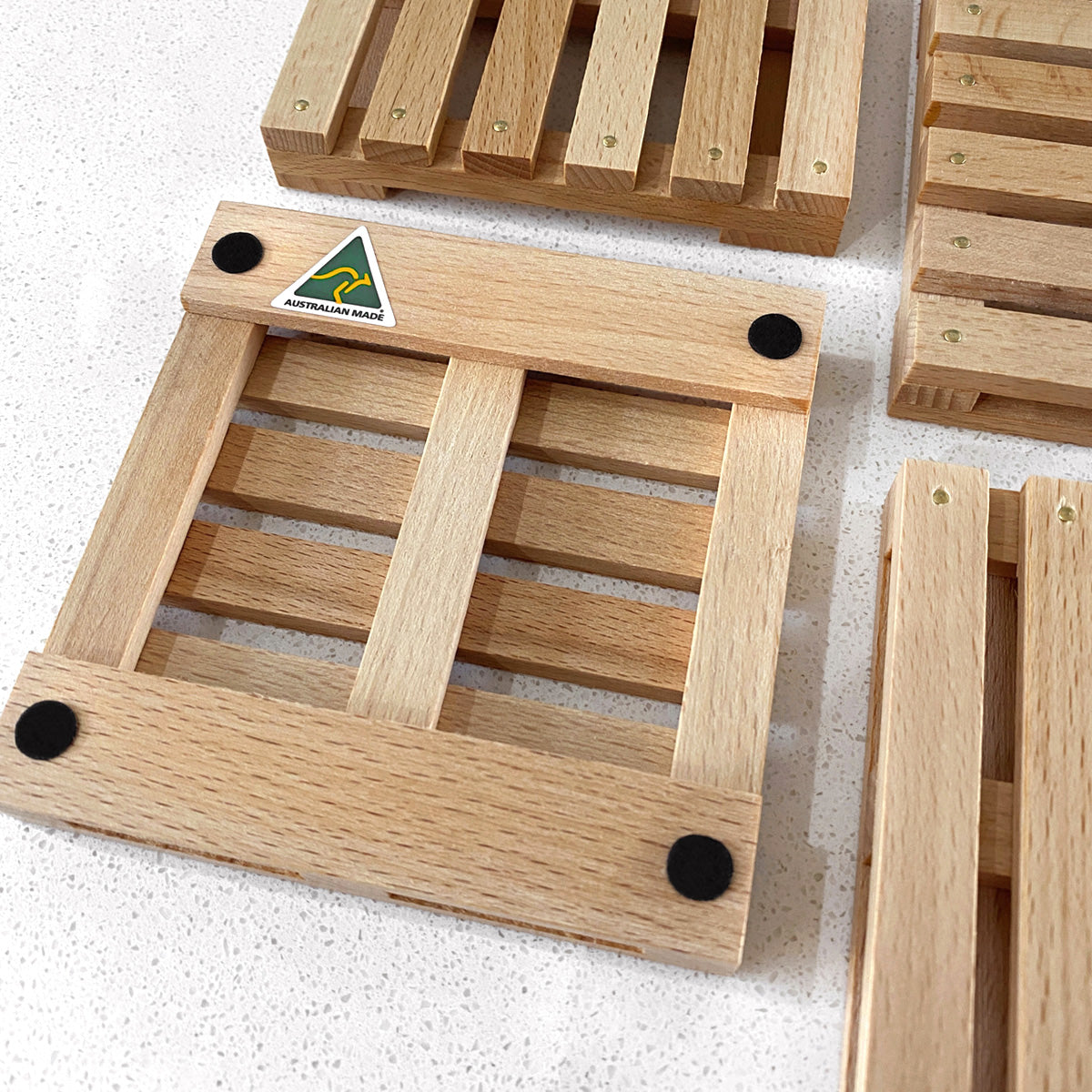 Mini Pallet Wooden Coasters. Set of 4. Close up view, showing rubber bumpers on the back.