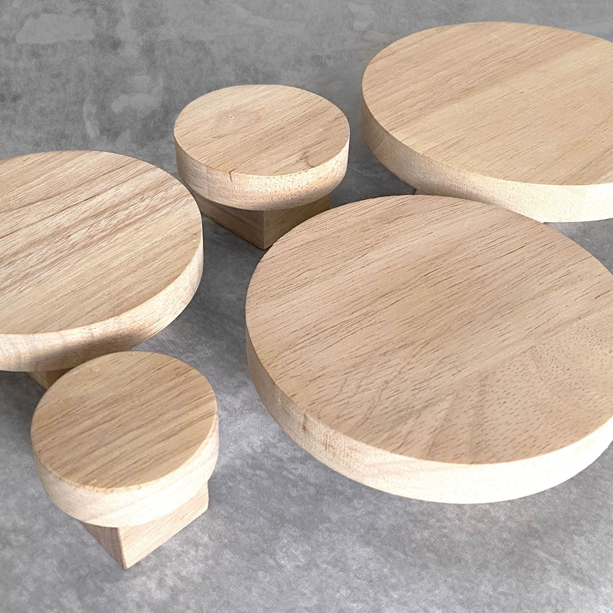 Round oak wall hooks on flat surface showing side view detail. All sizes shown.