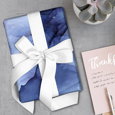 Watercolour Ink gift wrapping paper wrapped around a gift with white ribbon