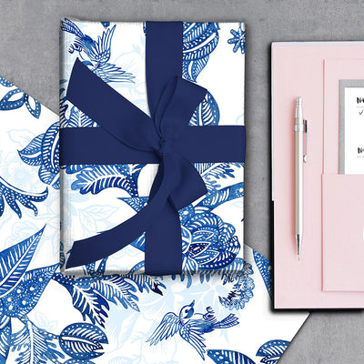 Hamptons Chinoiserie Paisley gift wrapping paper wrapped around a gift with navy ribbon